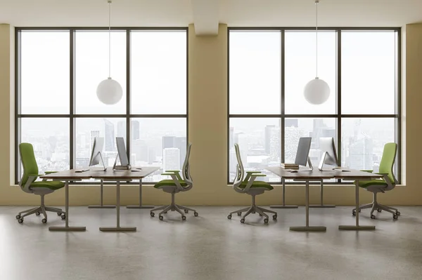Interior of modern open space office with yellow walls, concrete floor, comfortable computer tables with green chairs standing near big windows with cityscape. 3d rendering