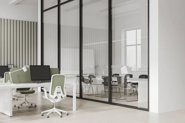 White workspace interior with coworking and conference zone, side view glass room with meeting table and chairs. Pc computers and office armchairs in row. 3D rendering