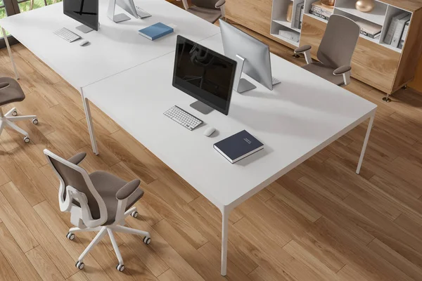 Top view of modern office interior with wooden floor and massive white computer table with brown chair standing near it. 3d rendering