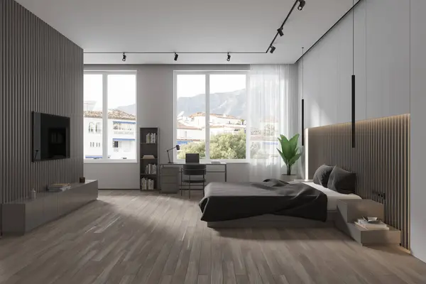 Interior of modern bedroom with white and gray walls, wooden floor, comfortable king size bed, home office corner with laptop standing on desk and big flat screen TV on wall. 3d rendering