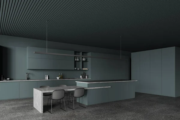 Dark green kitchen interior with stone table and bar counter, side view long cabinet on grey granite floor. Stylish dining and cooking space in luxury apartment. 3D rendering