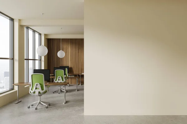 Stylish business interior with pc desktop on table in row, green armchairs on grey concrete floor. Cozy coworking space with panoramic window on skyscrapers. Mockup copy space partition. 3D rendering