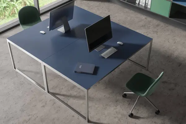 Top view of stylish office interior with concrete floor and two blue computer tables with green chairs standing near them. 3d rendering