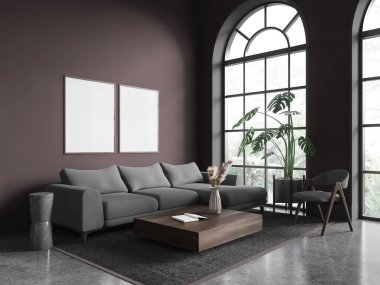Kahverengi duvarları, beton zemini olan şık oturma odasının köşesi kare sehpanın yanındaki halının üzerinde duran rahat gri kanepe ve iki dikey maket poster. 3d oluşturma