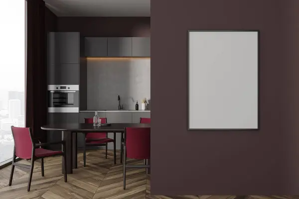 Dark home kitchen interior with dining table and chairs, hardwood floor. Grey cooking cabinet with oven and sink, panoramic window on skyscrapers. Mock up canvas poster on partition. 3D rendering