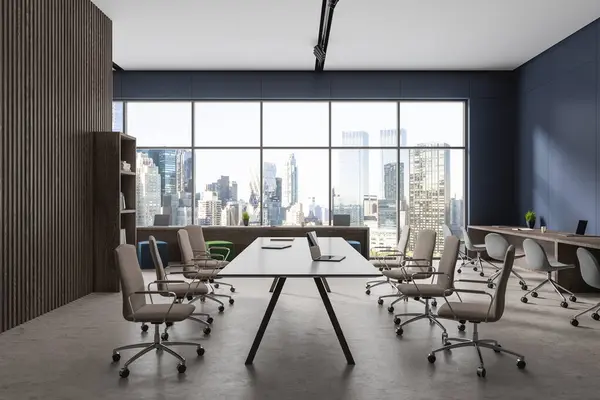 Modern blue office interior with armchairs and laptop on desk, light concrete floor. Modern office meeting and coworking zone, panoramic window on New York. 3D rendering