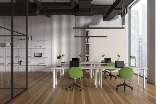 Modern coworking interior with green chairs and table in row, hardwood floor. Office learning or training room with laptop and shelf. Panoramic window on skyscrapers. 3D rendering