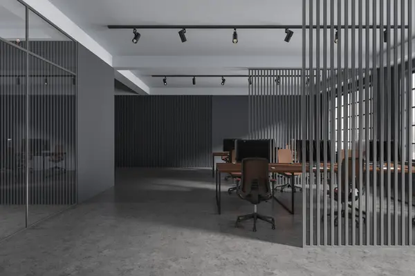 Dark coworking interior with pc desktop on table, partition and grey concrete floor. Office workspace with panoramic window on Kuala Lumpur skyscrapers. 3D rendering