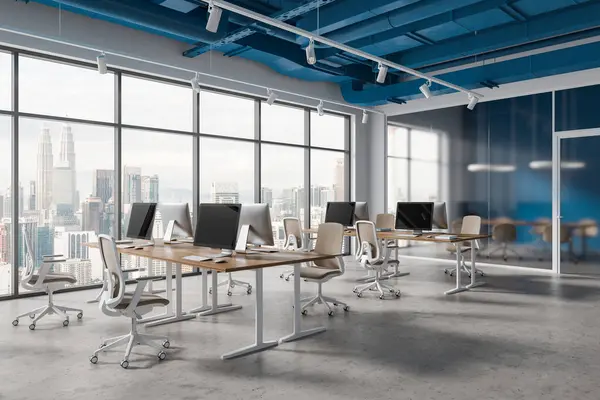 White and blue office loft interior with coworking and frosted glass meeting room, side view pc computers on desk and chairs in row. Panoramic window on Kuala Lumpur skyscrapers. 3D rendering