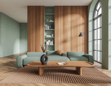 Yeşil duvarları, koyu ahşap zemini, uzun ahşap sehpanın yanında duran rahat yeşil kanepesi ve koyu ahşap kitaplığı olan şık bir oturma odası. 3d oluşturma