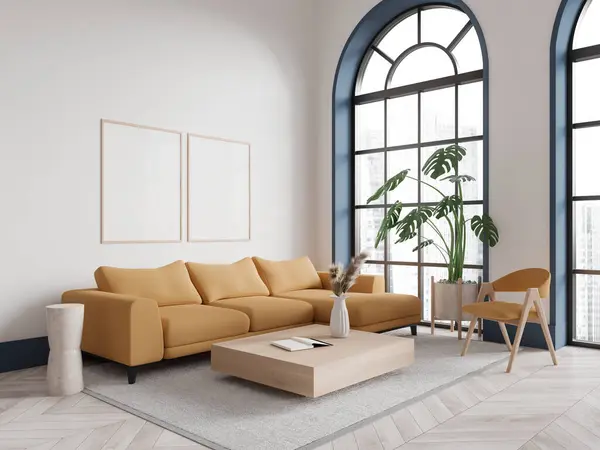 Corner of modern living room with white walls, wooden floor, comfortable yellow couch standing on carpet near square coffee table and two vertical mock up posters. 3d rendering