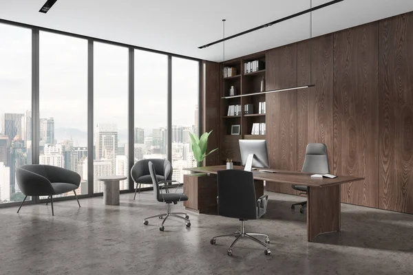 Corner of stylish CEO office with wooden walls, concrete floor, comfortable computer table, bookcase and cozy gray armchairs for visitors standing near panoramic window. 3d rendering