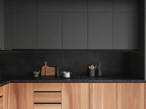 Wooden and black home kitchen interior with stove and pot, minimalist kitchenware on granite counter. Cooking space closeup in modern apartment. 3D rendering