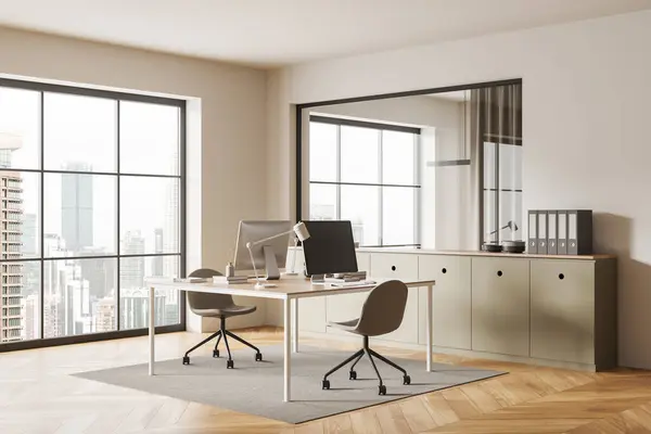 Stylish office interior with pc computers on a shared table, side view. Sideboard with folders and decoration. Panoramic window on Kuala Lumpur. 3D rendering
