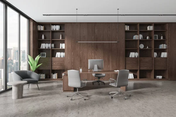 Stylish business room interior with pc computer on work desk, grey concrete floor. Modern consulting workplace with shelf and armchair. Panoramic window on Kuala Lumpur. 3D rendering