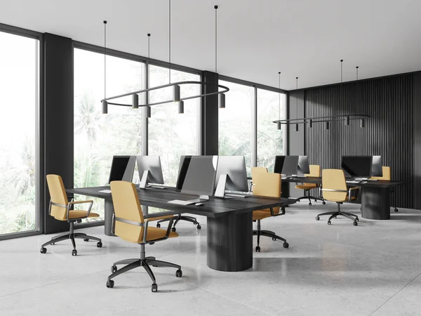 Corner of stylish open space office with gray and dark wooden walls, white tiled floor, rows of massive wooden computer tables with yellow chairs standing near panoramic windows. 3d rendering