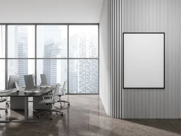 Interior of stylish open space office with white wooden walls, tiled floor, gray computer tables with white chairs and vertical mock up poster frame. 3d rendering