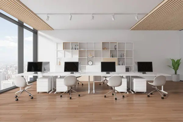 Modern office interior with pc monitor on shared table in row, shelf with art decoration. Stylish workplace with panoramic window on New York skyscrapers. 3D rendering