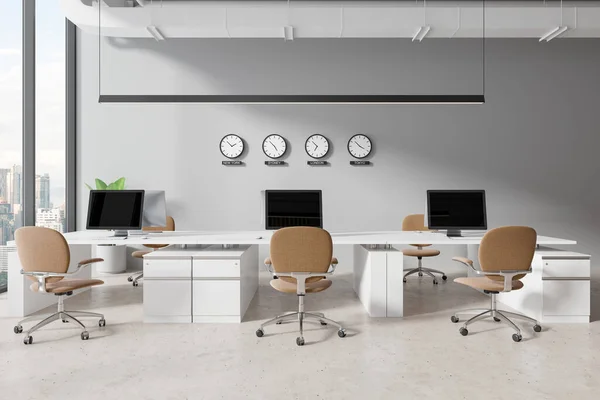 White cozy office interior with armchairs and pc computers on desk, light concrete floor. Stylish coworking space with drawer, world clock and panoramic window on Kuala Lumpur. 3D rendering