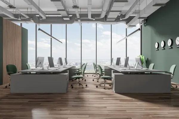 Interior of stylish open space office with green and wooden walls, wooden floor, gray computer desks with green chairs standing near panoramic window and clocks showing world time. 3d rendering