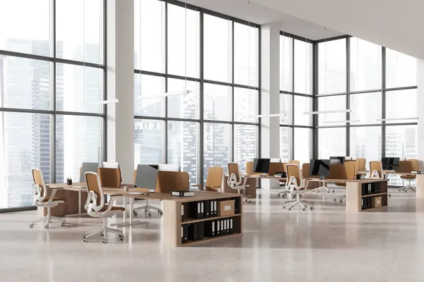 Corner of modern open space office with white walls, concrete floor, rows of computer desks with beige chairs and panoramic windows with cityscape. 3d rendering