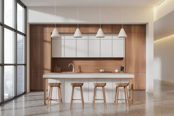 Interior of modern office kitchen with white and wooden walls, concrete floor, white cabinets with built in cooker and sink and bar counter with stools. 3d rendering