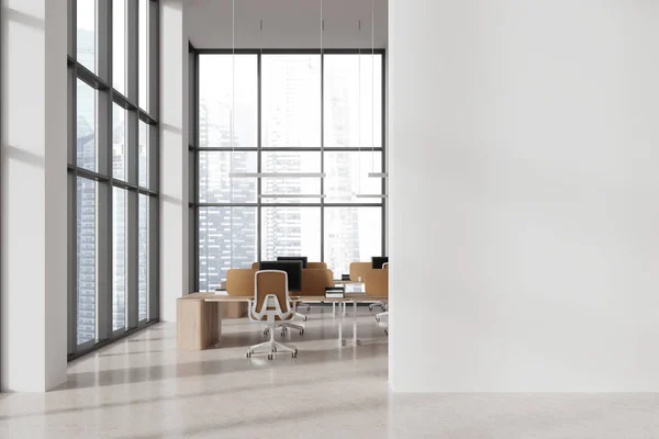 Interior of modern open space office with white walls, concrete floor, rows of computer desks with beige chairs and panoramic windows with cityscape. Copy space wall on the right. 3d rendering