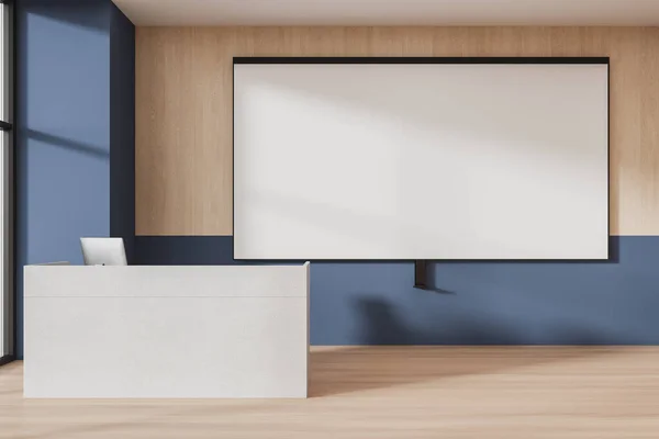Wooden and blue auditorium interior with desk and pc computer, mock up empty projection screen on wall. Minimalist cozy lecture room with table and equipment. 3D rendering