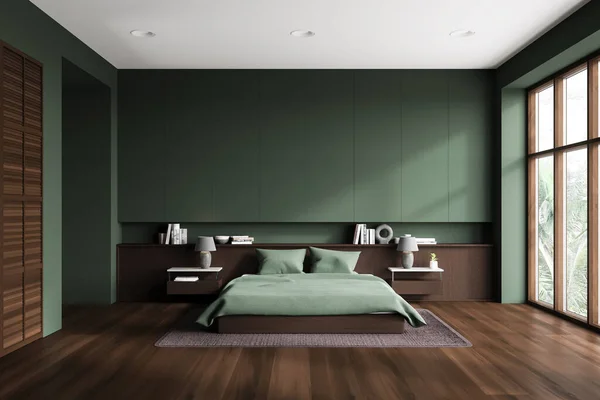 Dark bedroom interior with bed and green wall, nightstand with books and carpet on hardwood floor. Sleep room with wooden shelf and panoramic window on tropics. 3D rendering