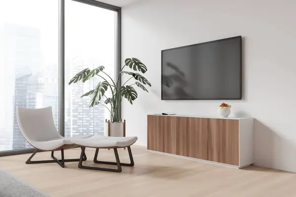 Corner of modern living room with white walls, wooden floor, comfortable white armchair, wooden dresser and modern flat screen TV set hanging above it. 3d rendering