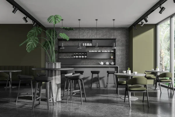 Interior of stylish restaurant with green and gray tiled walls, concrete floor, cozy gray bar counter with stools, round tables with green chairs and comfortable sofa. 3d rendering