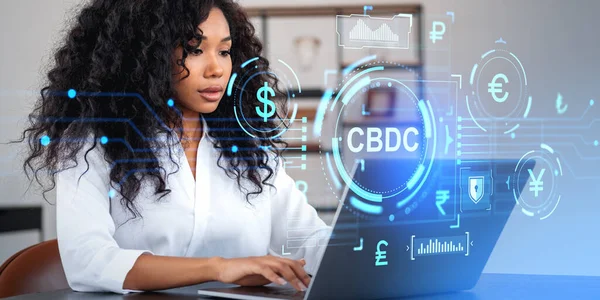 African woman typing in laptop, side view. Central bank digital currency hud hologram, virtual screen with icons and indicators. Concept of CBDC, digital assets and blockchain