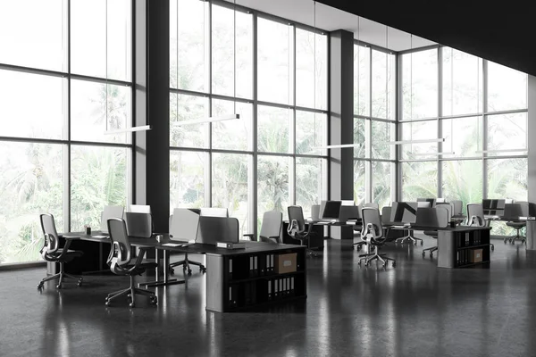 Corner of stylish open space office with gray walls, concrete floor, rows of computer desks with gray chairs and panoramic windows with tropical view. 3d rendering