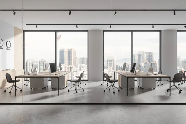Interior of modern open space office with white, wooden and glass walls, concrete floor, rows of computer desks with gray chairs and clocks showing world time. 3d rendering