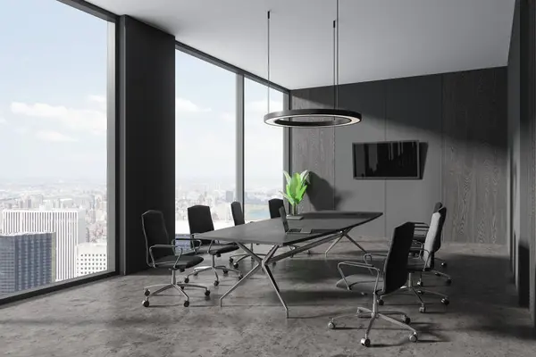 Corner of stylish office meeting room with gray and dark wooden walls, concrete floor, long conference table with gray chairs and flat screen TV on the wall. 3d rendering
