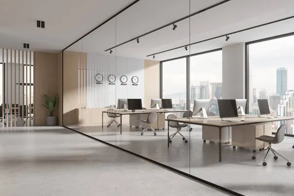 Corner of modern open space office with white, wooden and glass walls, concrete floor, rows of computer desks with gray chairs and clocks showing world time. 3d rendering