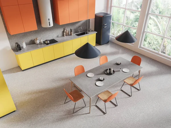 Top view of hotel kitchen interior with dining table and chairs, grey granite floor. Orange and yellow cooking corner with cabinet and fridge. Panoramic window on tropics. 3D rendering