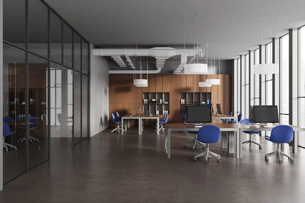 Dark office interior with coworking and glass meeting room, shelf with documents and armchairs with pc computers in row. Panoramic window on city skyscrapers. 3D rendering