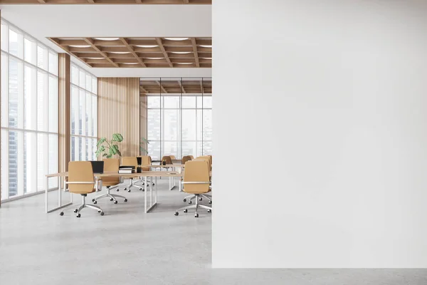 Interior of modern open space office with white and wooden walls, wooden computer desks with beige chairs, conference room in background and mock up wall on the right. 3d rendering