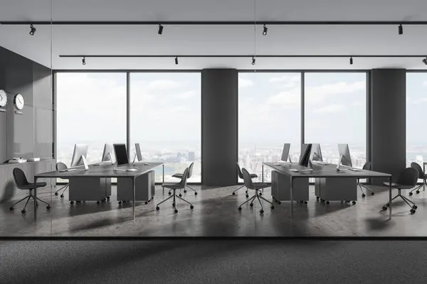 Interior of stylish open space office with gray , wooden and glass walls, concrete floor, rows of computer desks with gray chairs and clocks showing world time. 3d rendering