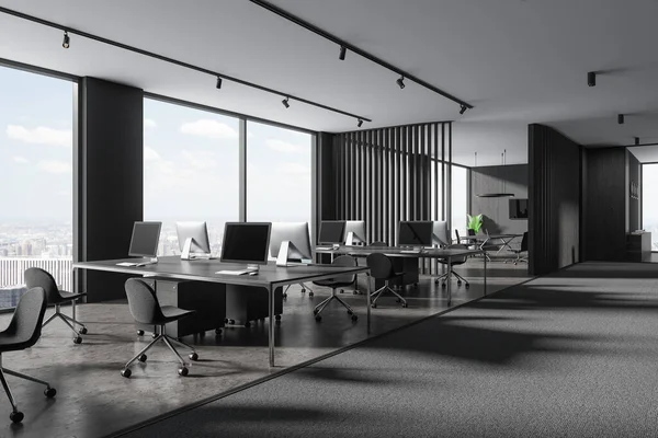 Dark office interior with workplace, side view pc computers on shared table in row. Meeting space with board and panoramic window on skyscrapers. 3D rendering