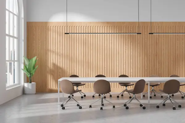 Light conference interior with chairs and board, plant in the corner on light concrete floor. Cozy minimalist meeting room and panoramic window on skyscrapers. 3D rendering