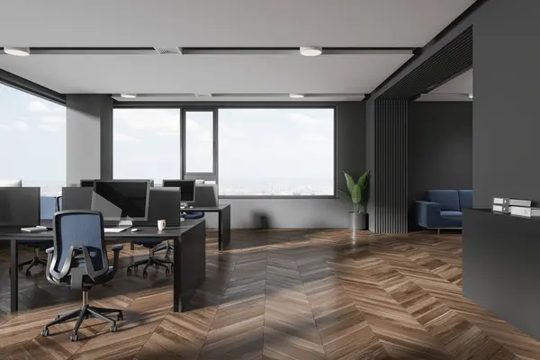 Interior of stylish open space office with gray walls, wooden floor, row of gray computer desks with blue chairs and big windows with cityscape. 3d rendering