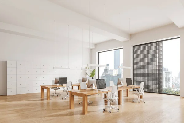 Corner of modern open space office with white walls, wooden floor and massive wooden computer desks with white chairs. 3d rendering