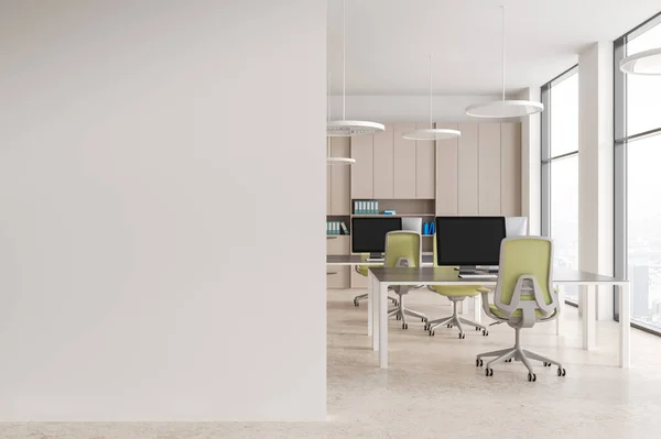 Interior of modern open space office with white walls, stone floor, row of computer tables with green chairs and beige bookcase with folders. Copy space wall on the left. 3d rendering
