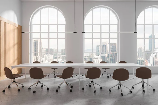 Modern meeting interior with chairs and board, light concrete floor. Minimalist conference room and panoramic window on Kuala Lumpur skyscrapers. 3D rendering