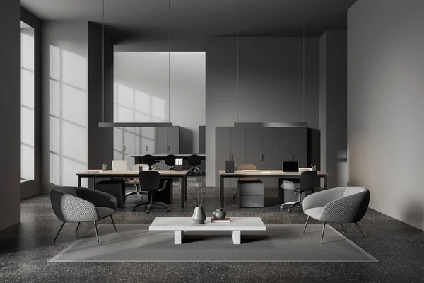 Dark office interior with lounge zone and desk with laptop, carpet on grey granite floor. Stylish business room with meeting space with board on background. 3D rendering