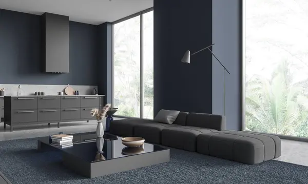 Interior of stylish living room with blue walls, concrete floor, comfortable gray couch standing near coffee table and kitchen with gray island in the background. 3d rendering