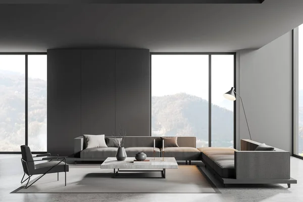Dark relax room interior with sofa and armchair, coffee table with minimalist decoration and carpet on grey concrete floor. Chill place with panoramic window on countryside. 3D rendering