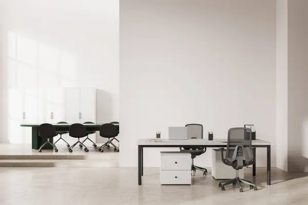 Interior of modern office meeting room with white walls, concrete floor, long green conference table with chairs and computer desk standing near copy space wall. 3d rendering